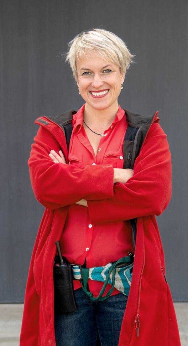 Eine Frau mit roten Klamotten lächelt in die Kamera